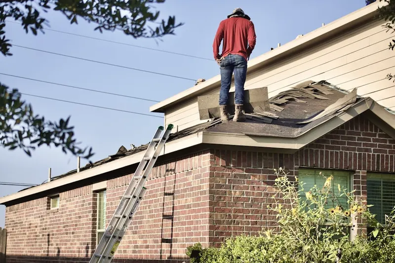 Professional roofer working on a residential roof in Howard Hills
